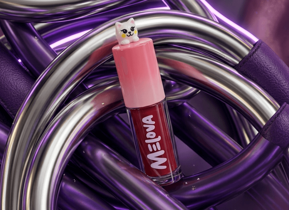 Melova Glow Filter Tint bottle on a glossy purple set